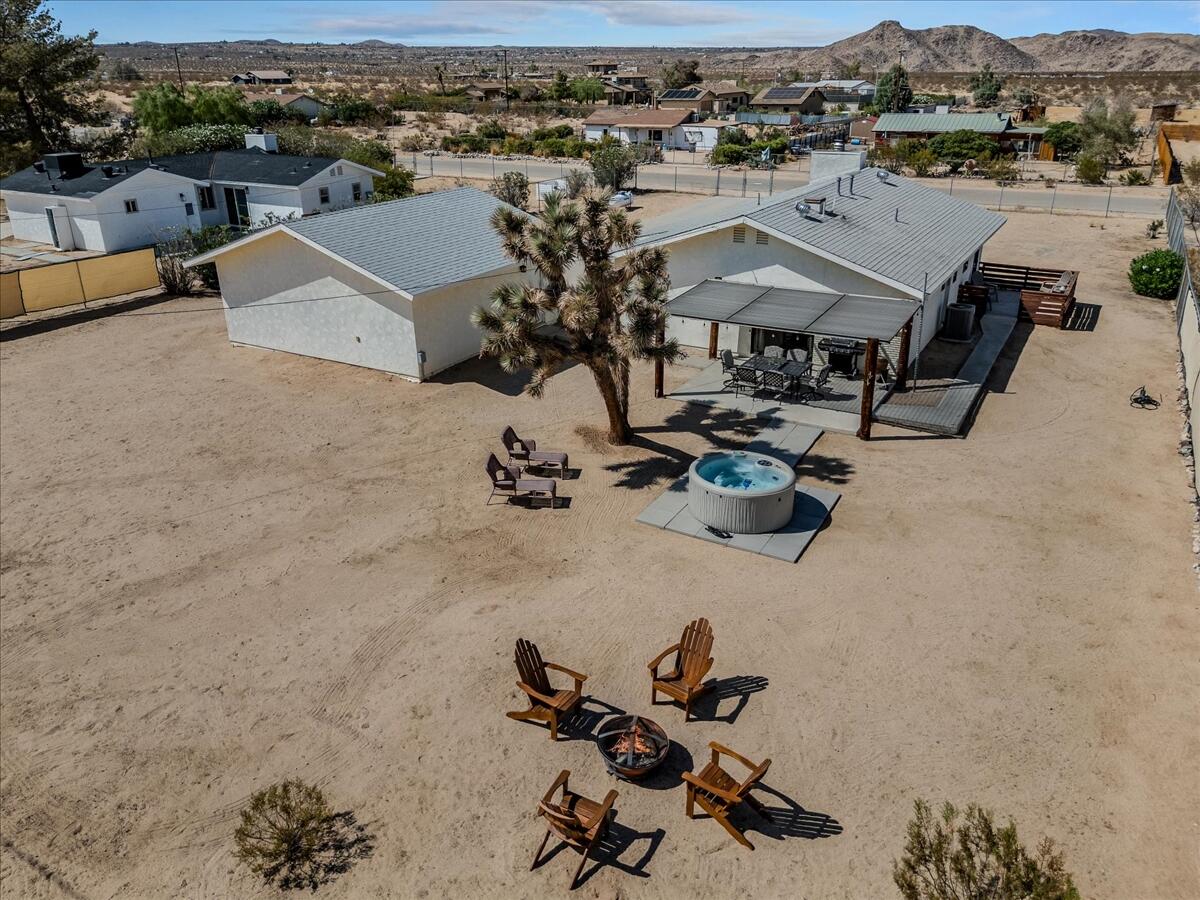 63555 Walpi Drive Joshua Tree, CA 92252 - Photo 26 of 30 an aerial view of a yard with horses
