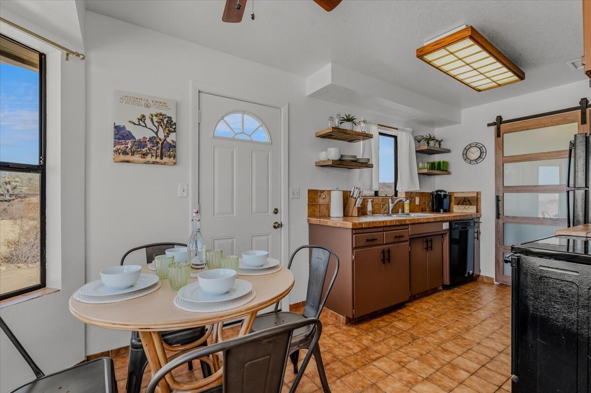 63555 Walpi Drive Joshua Tree, CA 92252 - Photo 10 of 30 a kitchen with stainless steel appliances kitchen island granite countertop a sink and cabinets