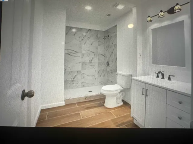 a bathroom with a sink toilet a shower and a mirror