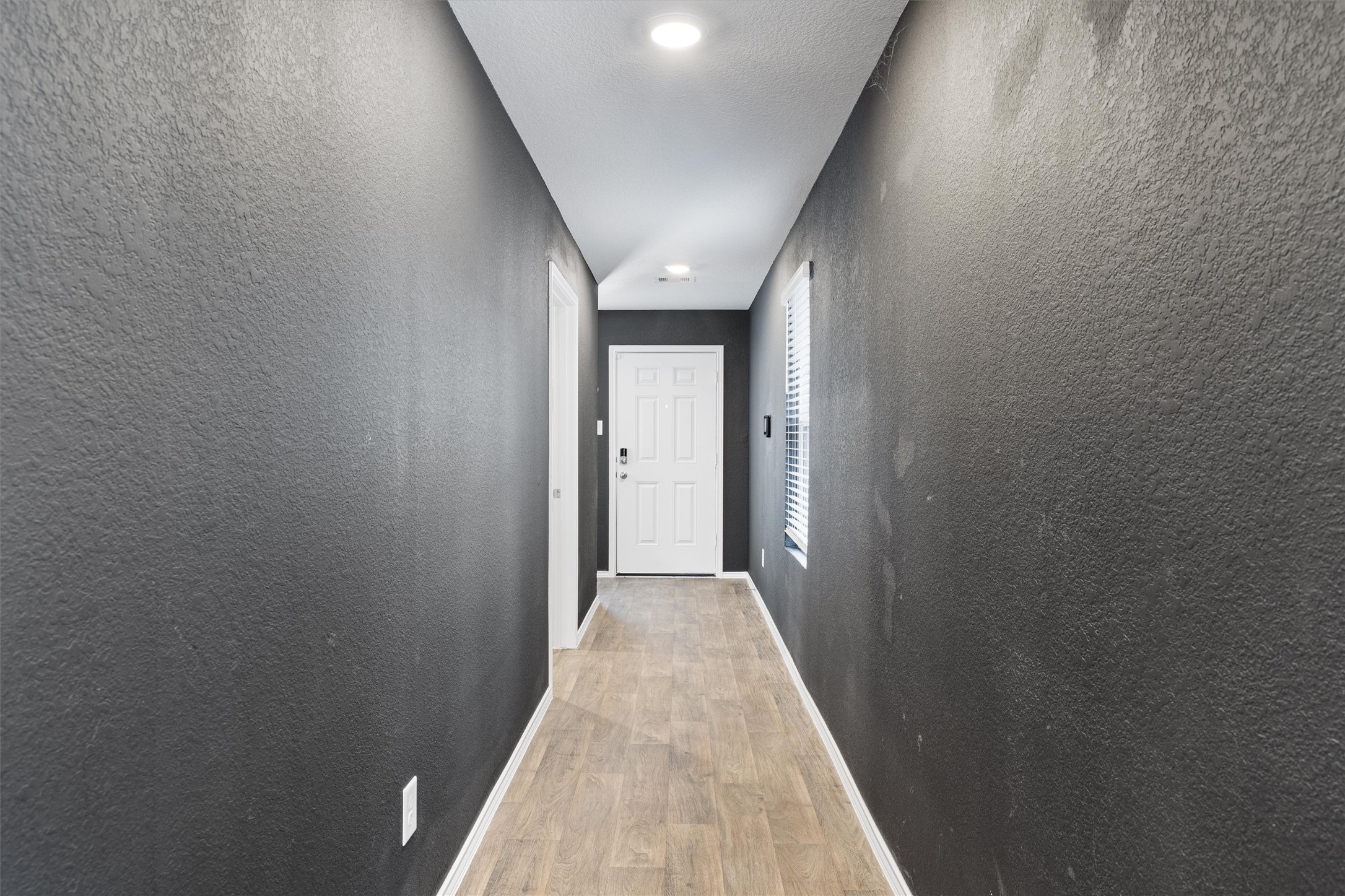 352 Sickle Loop Uhland, TX 78640 - Photo 6 of 36 Entryway view to the front door and secondary bedrooms.