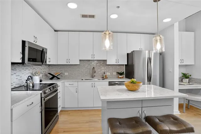 a kitchen with a sink a stove and refrigerator
