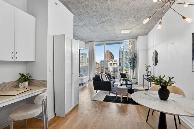 a view of a dining room with furniture window and wooden floor
