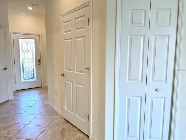 a view of a hallway with white doors