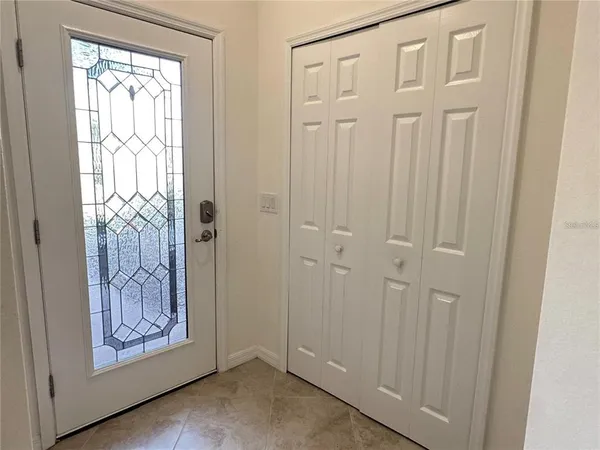 a view of an entryway with a wooden door