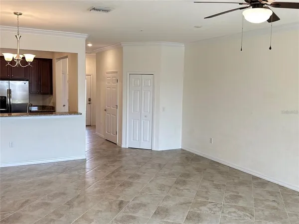 a view of a kitchen with a sink and a refrigerator