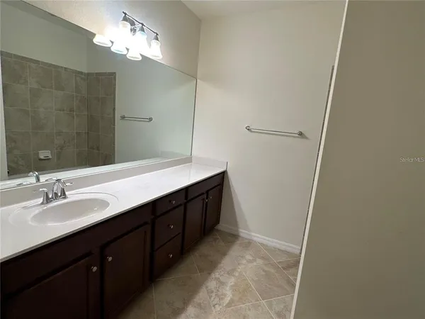a bathroom with a double vanity sink a and a mirror