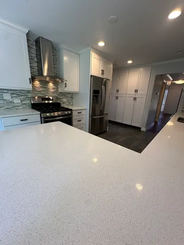 a kitchen with stainless steel appliances a refrigerator and stove