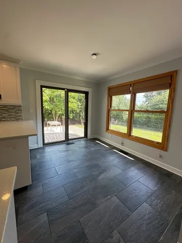 an empty room with large windows