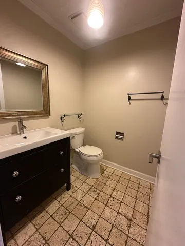 a bathroom with a double vanity sink toilet and mirror