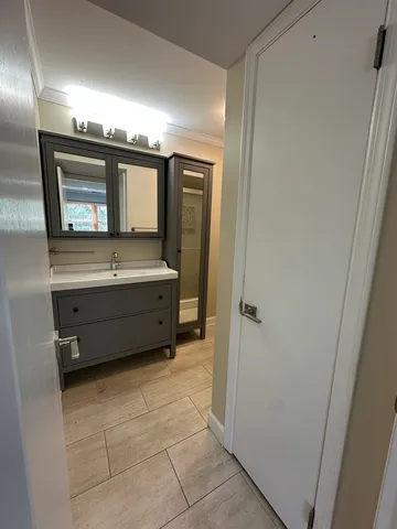 a bathroom with a sink a mirror and a bathtub