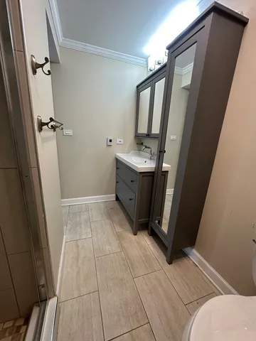 a bathroom with a sink toilet and shower