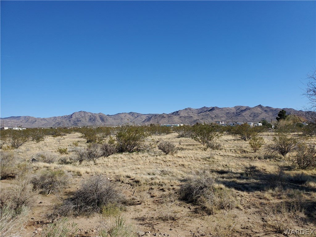 Lot 14 Aztec Road Golden Valley, AZ 86413 - Photo 6 of 9 a view of a lake with mountains in the background