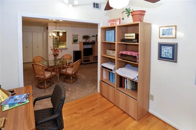 a view of a workspace with furniture and a window