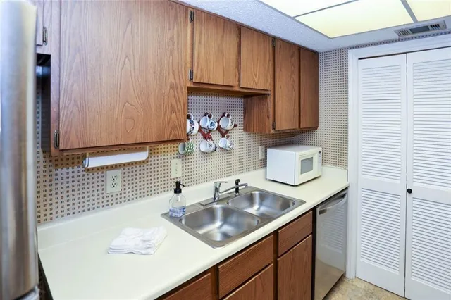 a kitchen with stainless steel appliances granite countertop a refrigerator and a sink