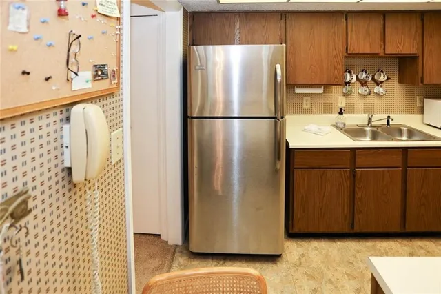 a kitchen with stainless steel appliances granite countertop a stove and a refrigerator