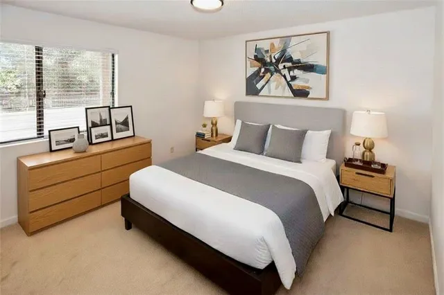 a spacious bedroom with a bed and window