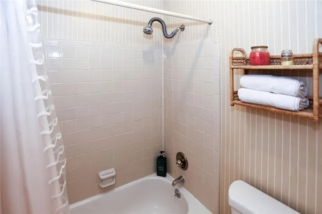a view of hallway with cabinets and refrigerator
