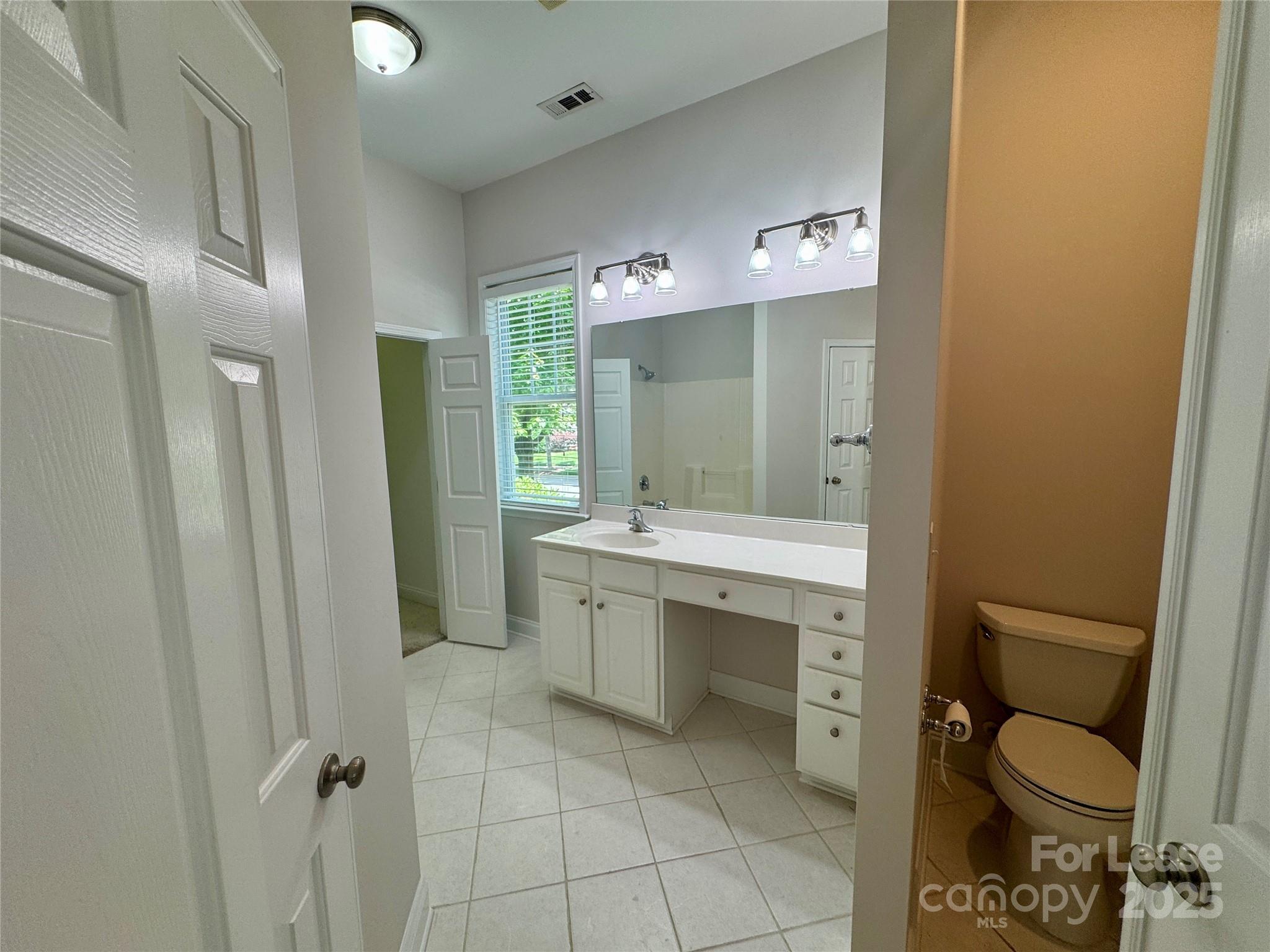 5340 Soaring Eagle Lane Mint Hill, NC 28227 - Photo 24 of 28 a bathroom with a toilet sink and mirror