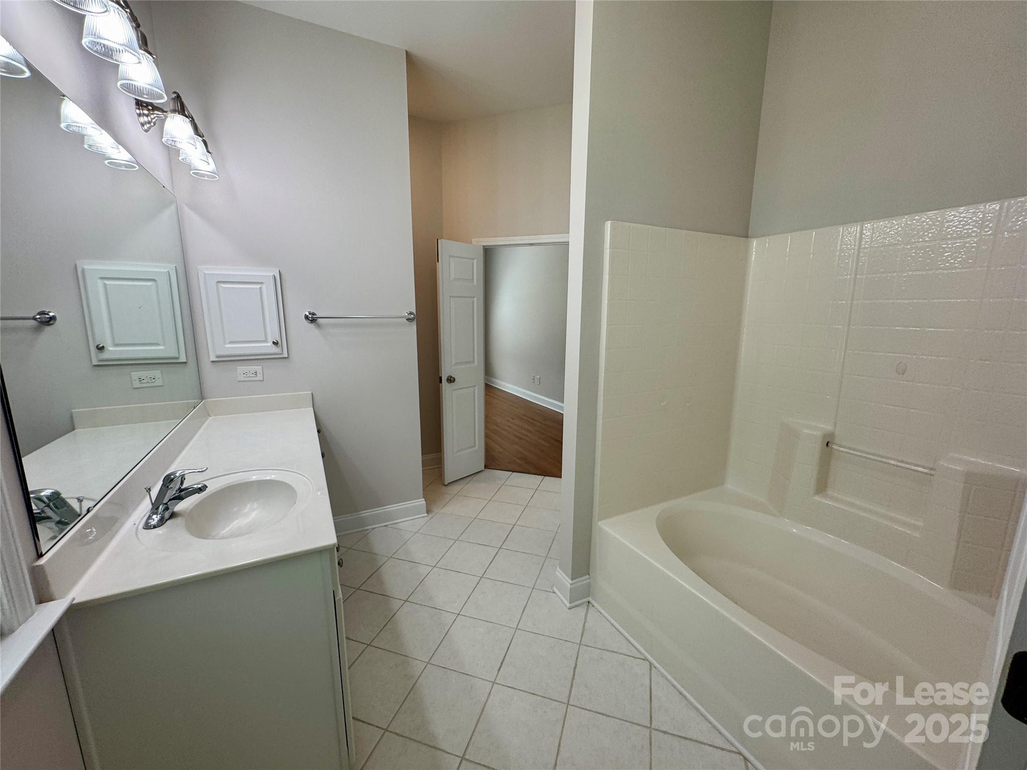 5340 Soaring Eagle Lane Mint Hill, NC 28227 - Photo 27 of 28 a bathroom with a sink and tub