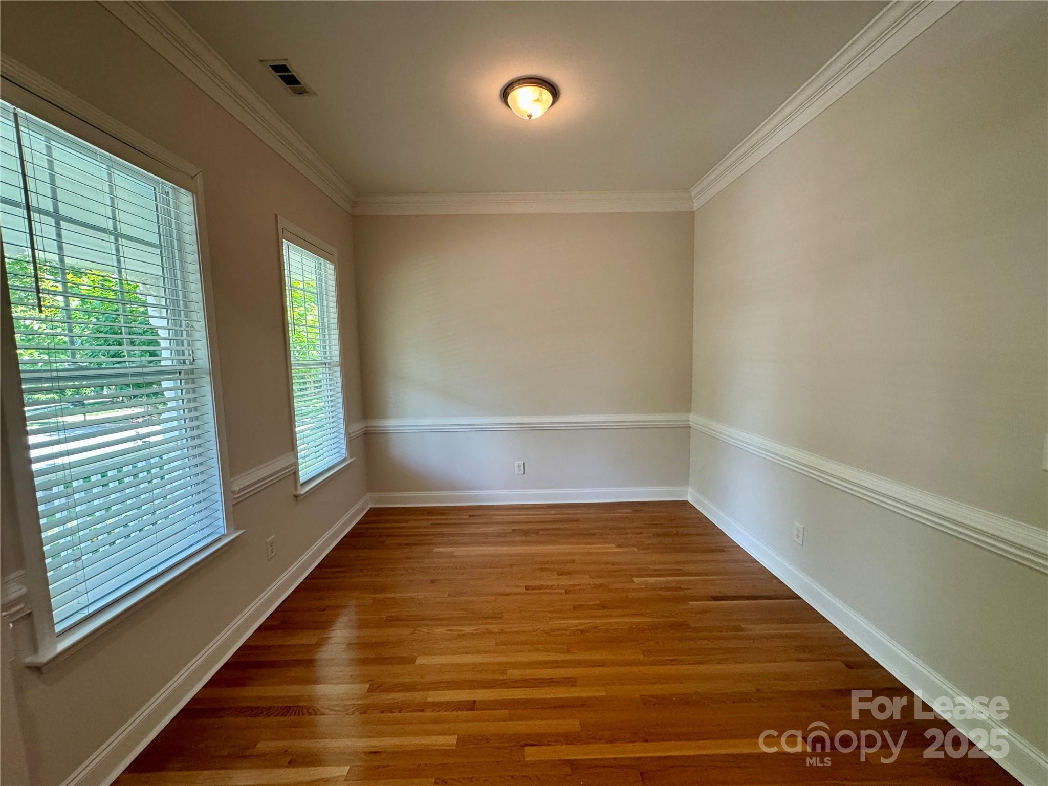 5340 Soaring Eagle Lane Mint Hill, NC 28227 - Photo 6 of 28 a view of an empty room with wooden floor and a window