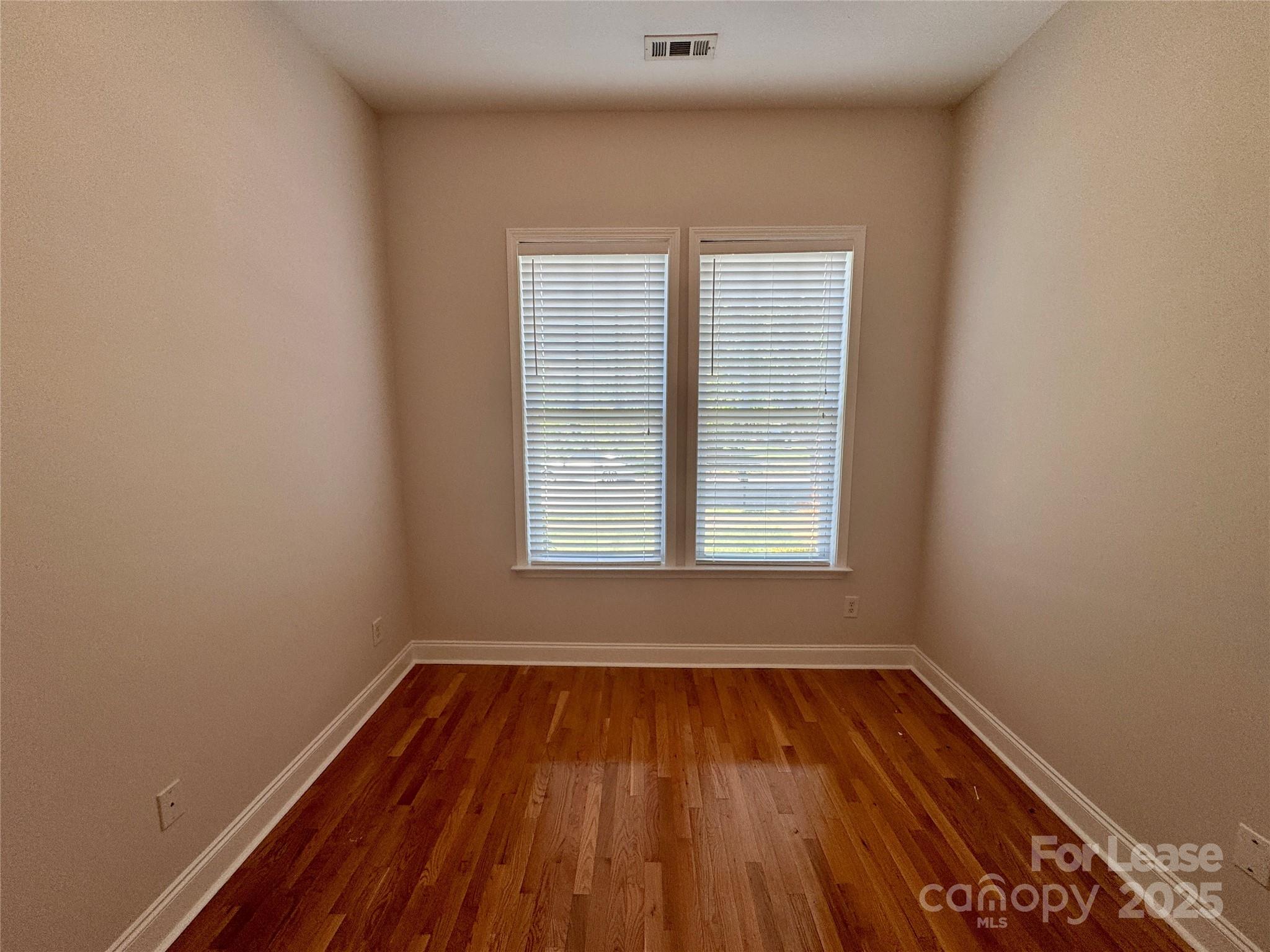 5340 Soaring Eagle Lane Mint Hill, NC 28227 - Photo 9 of 28 an empty room with wooden floor and windows