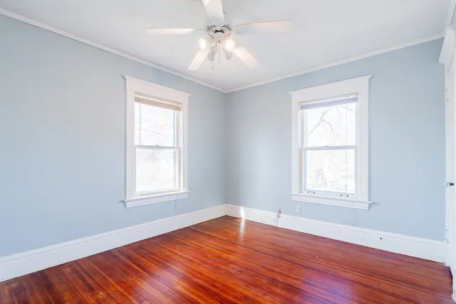 a view of an empty room with wooden floor
