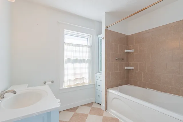 a bathroom with a sink vanity and a mirror