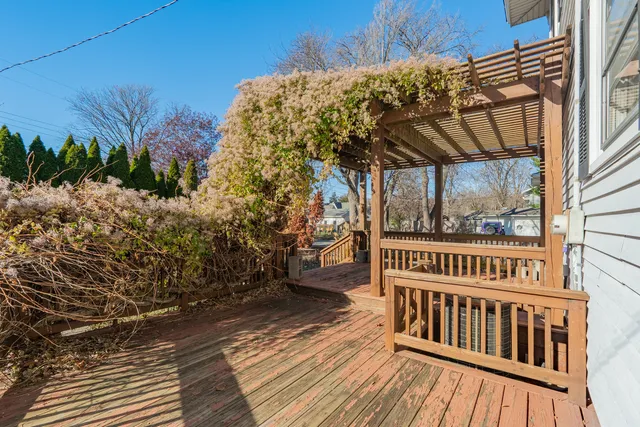 a view of a porch with wooden floor and fence