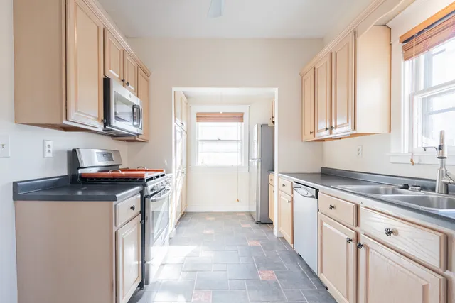 a kitchen with stainless steel appliances a stove a microwave and cabinets