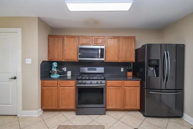 a kitchen with a refrigerator stove and microwave