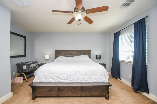 a bedroom with a bed and window