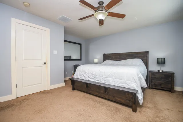 a bedroom with a bed and a chandelier