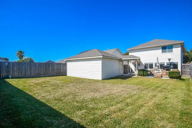 a view of backyard of house and car parked