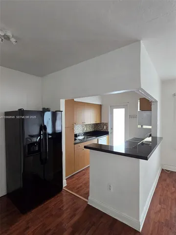 a kitchen with stainless steel appliances a refrigerator and a stove