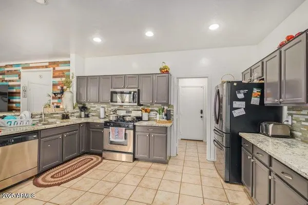 a kitchen with stainless steel appliances granite countertop a sink and cabinets