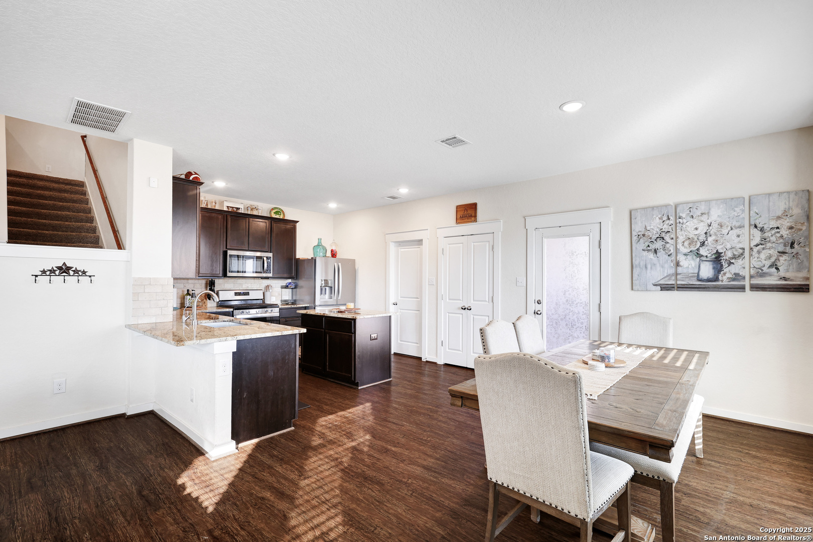 10614 Rosalina Loop Converse, TX 78109 - Photo 11 of 31 a living room with stainless steel appliances furniture a flat screen tv and kitchen view