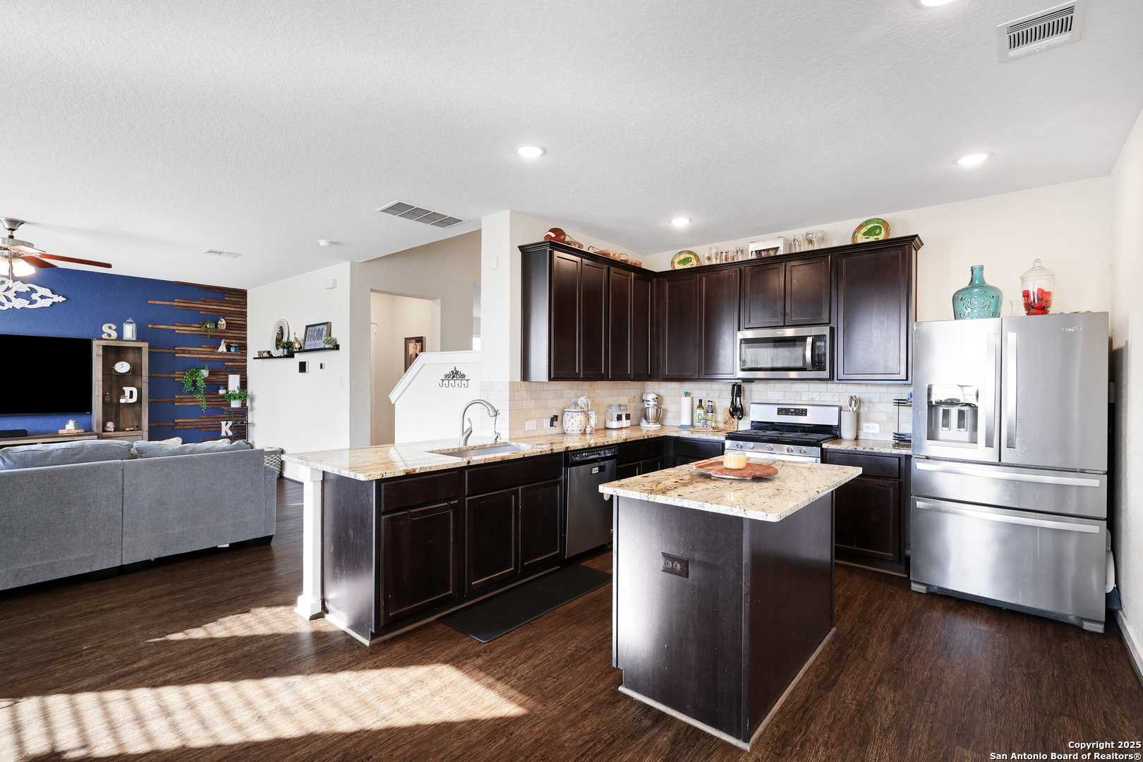 10614 Rosalina Loop Converse, TX 78109 - Photo 13 of 31 a kitchen with stainless steel appliances granite countertop a sink stove and refrigerator