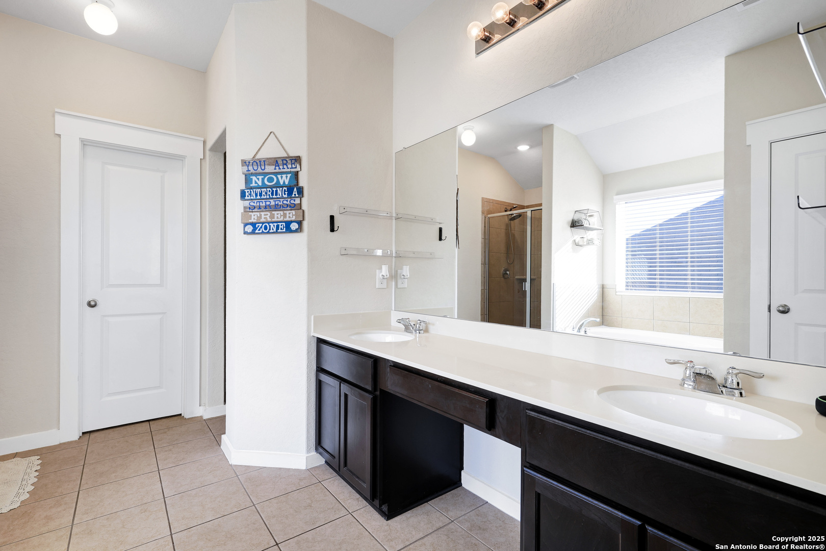 10614 Rosalina Loop Converse, TX 78109 - Photo 22 of 31 a bathroom with a sink double vanity and a mirror