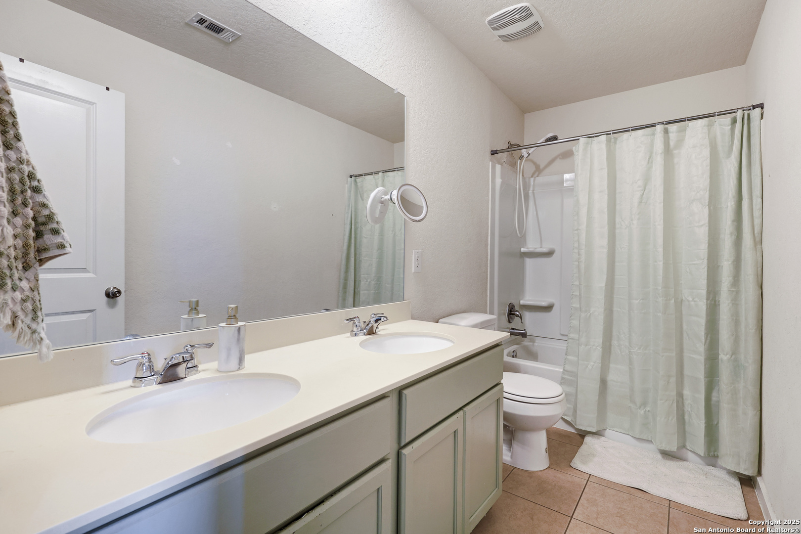 10614 Rosalina Loop Converse, TX 78109 - Photo 26 of 31 a bathroom with a double vanity sink toilet mirror and shower