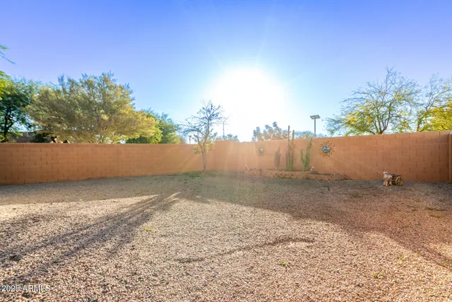 a view of a house with a backyard