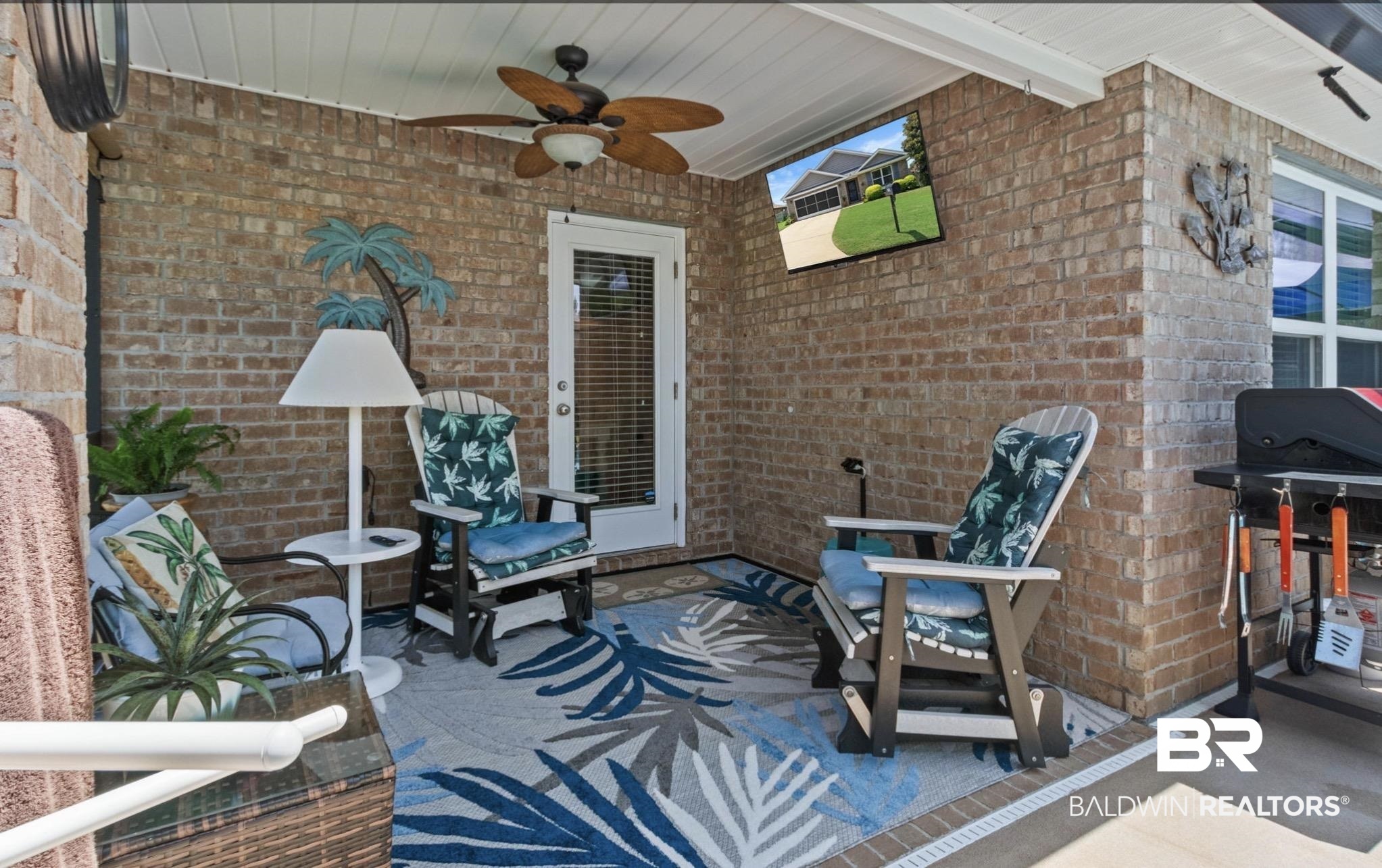 1676 Abbey Loop Foley, AL 36535 - Photo 10 of 31 Covered patio featuring a brick exterior, white ceiling, and a ceiling fan with light fixture
