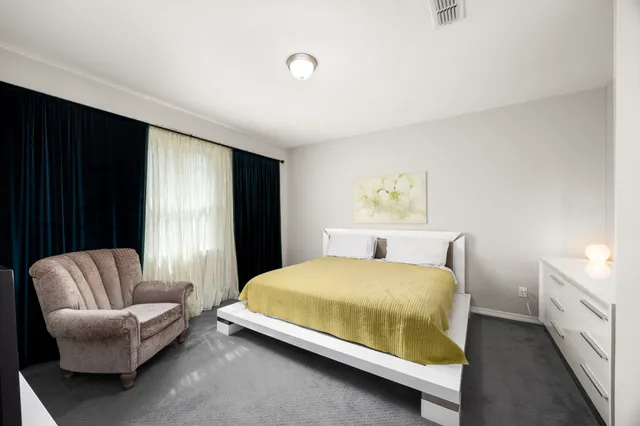 a bedroom with a bed and a couch