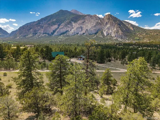 a view of a building with mountains in the background