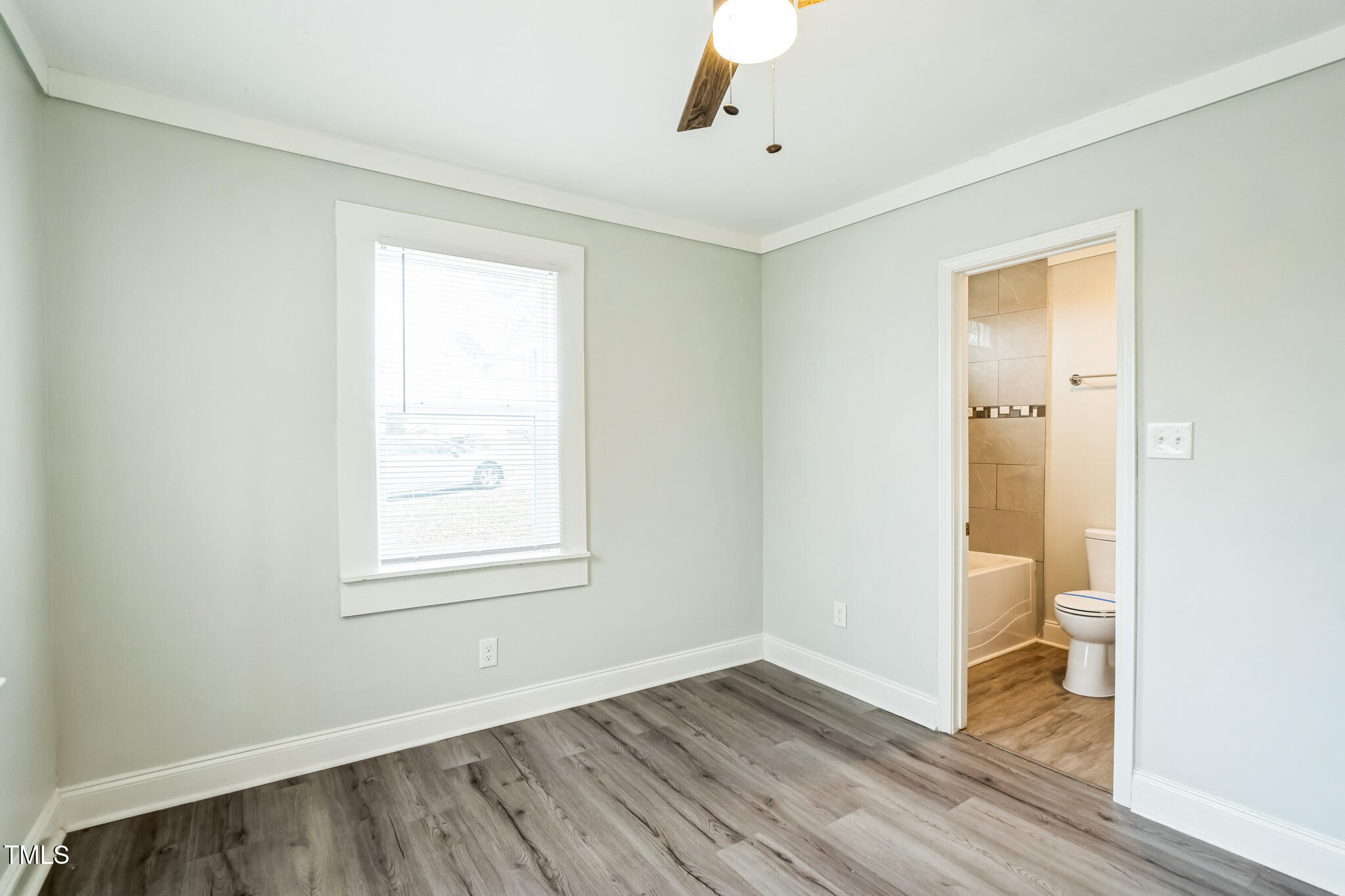2400 Dorety Place Raleigh, NC 27604 - Photo 14 of 29 a view of an empty room with wooden floor and a window