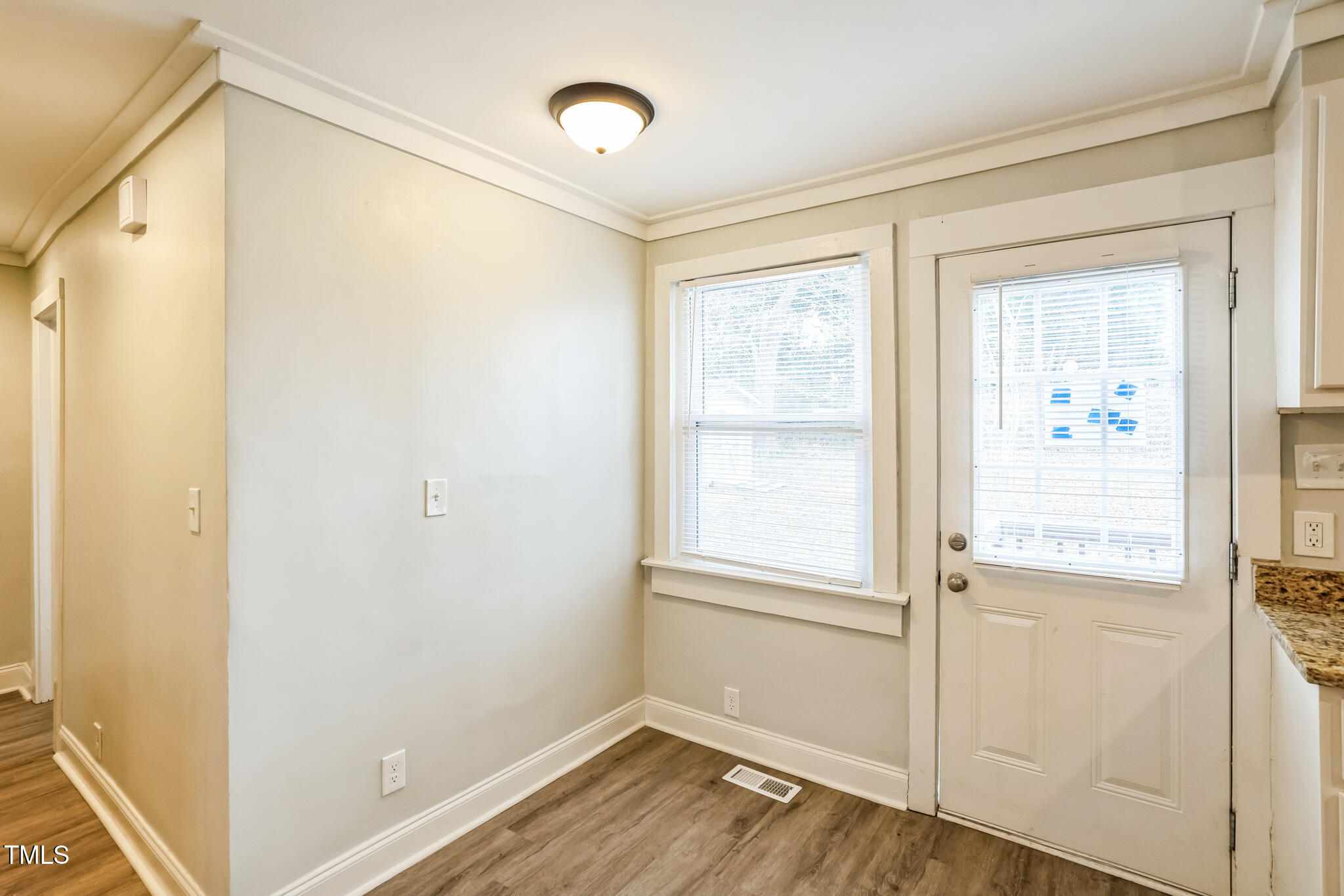 2400 Dorety Place Raleigh, NC 27604 - Photo 20 of 29 a view of an empty room with wooden floor and a window