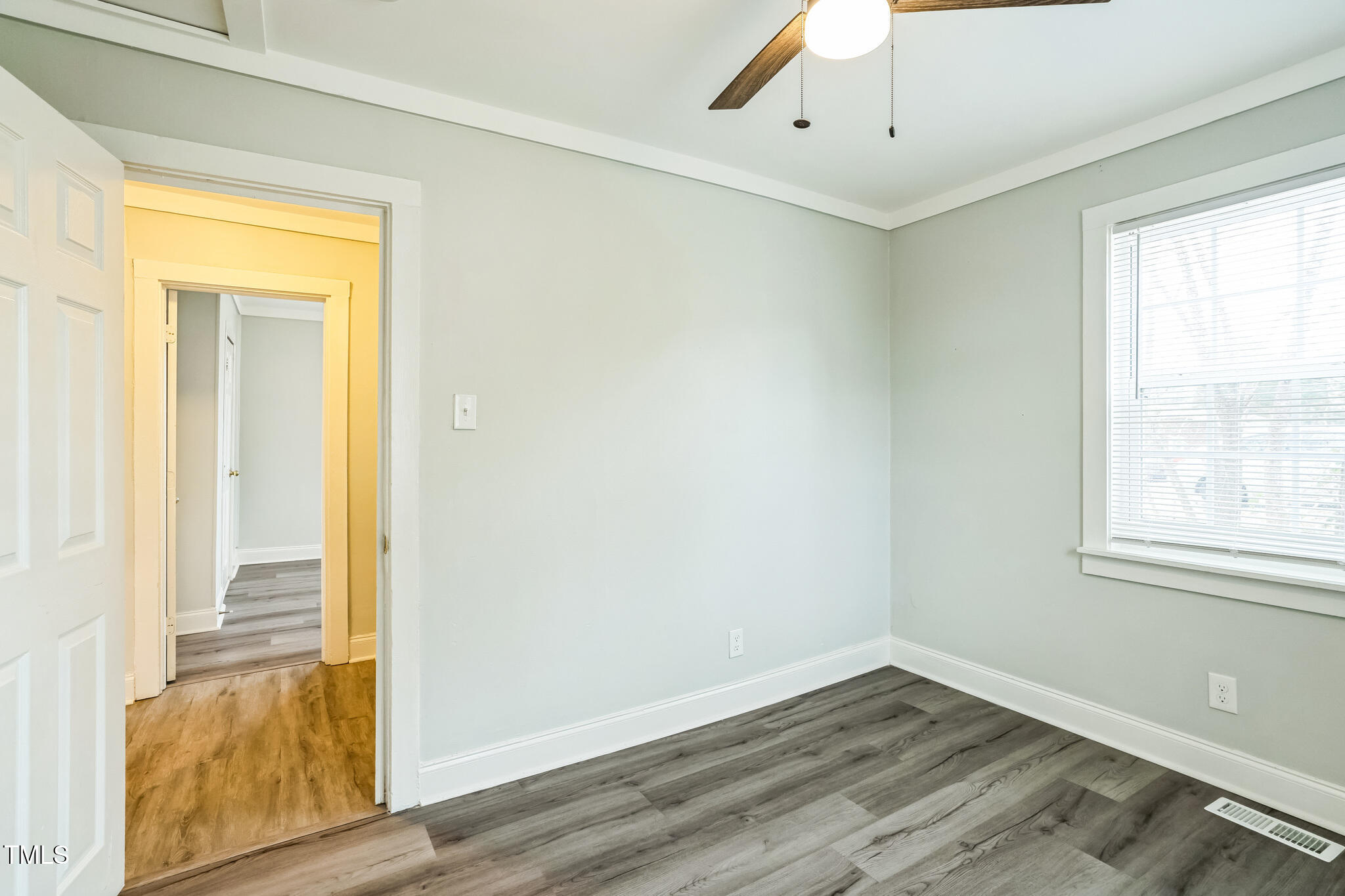2400 Dorety Place Raleigh, NC 27604 - Photo 25 of 29 a view of an empty room with wooden floor and a window
