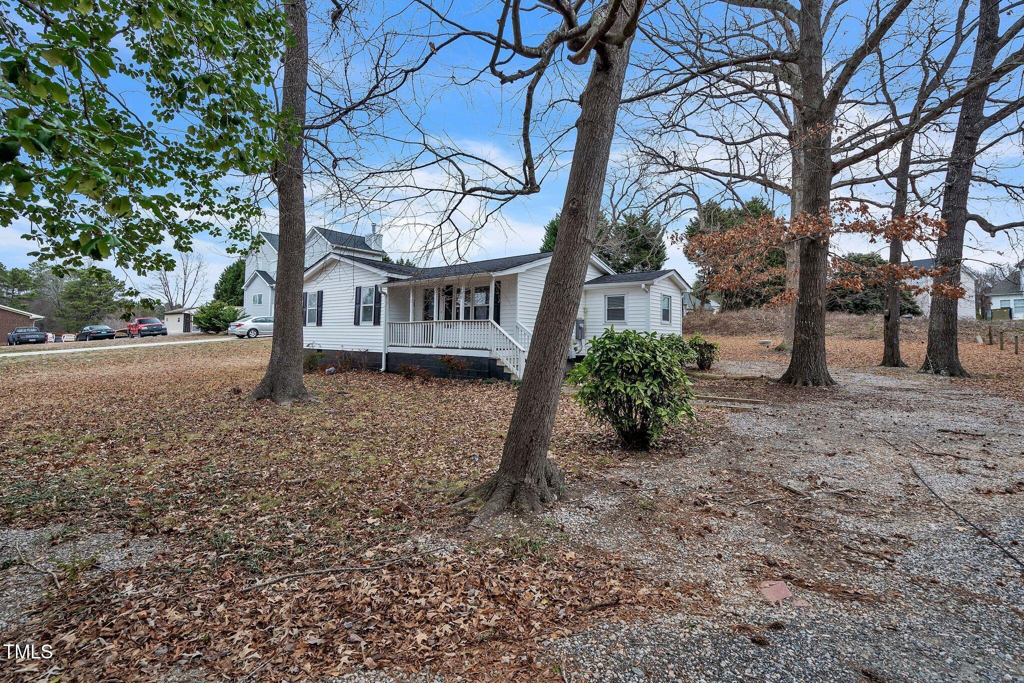 2400 Dorety Place Raleigh, NC 27604 - Photo 29 of 29 a view of a house with a yard tree and a wooden fence