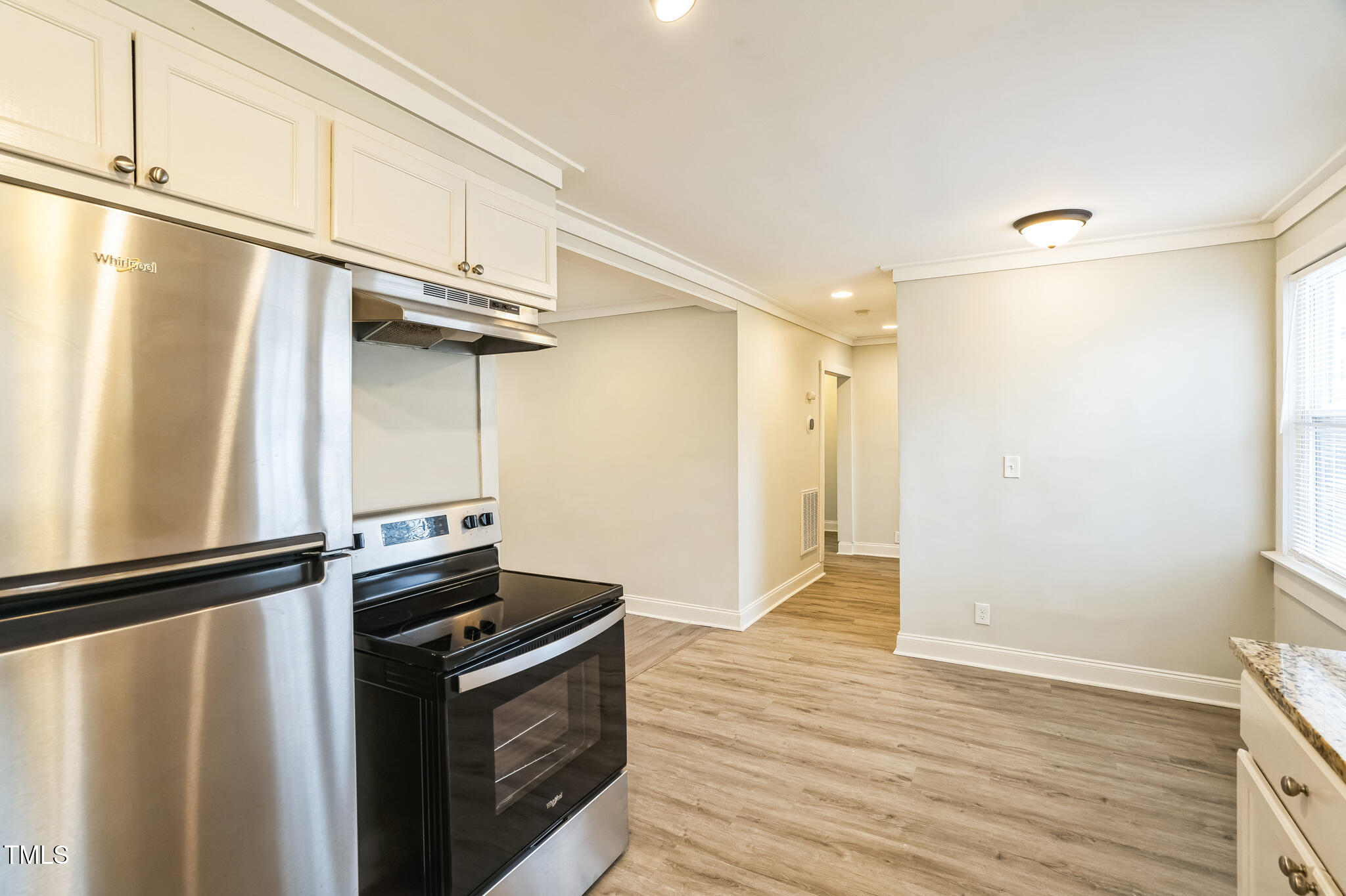 2400 Dorety Place Raleigh, NC 27604 - Photo 7 of 29 a view of a kitchen with wooden floor and a refrigerator