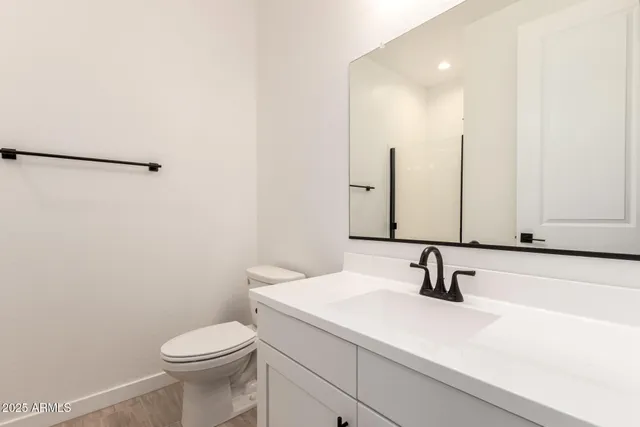 a bathroom with a sink a toilet and mirror