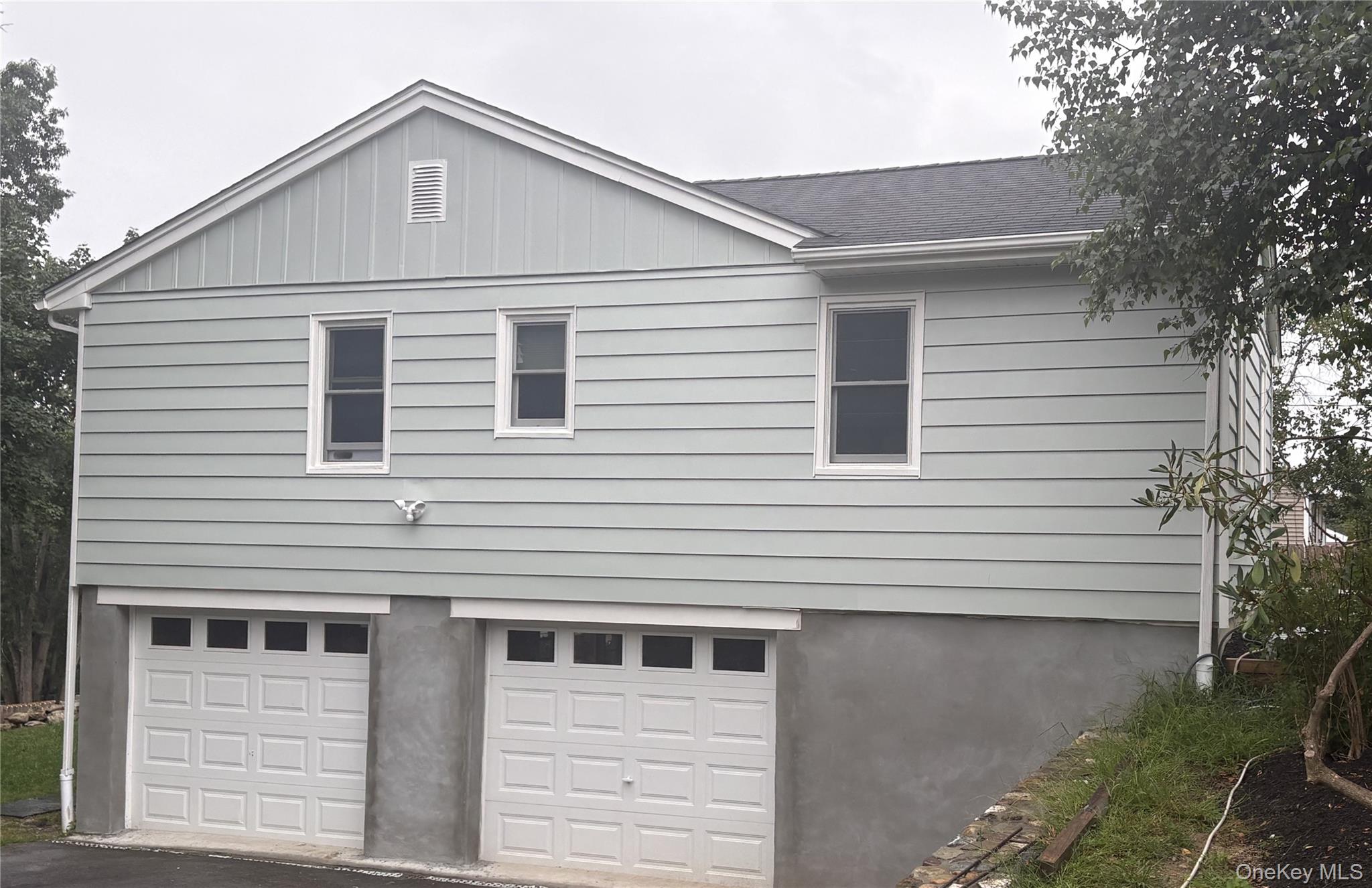 18 Robin Hill Road Poughkeepsie, NY 12603 - Photo 3 of 20 Side of house and entrance into garage bays